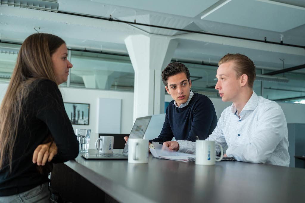 Employees and a graduate student in joint consultation